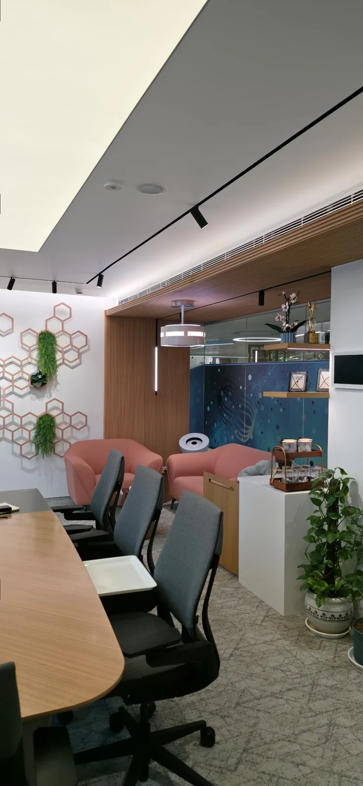 dp air purifier in an office with a meeting table and lounge seating