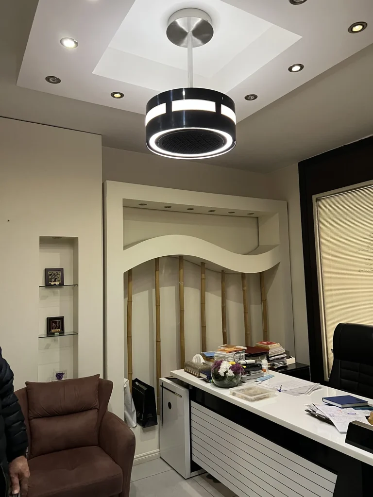 Black dp air purifier above an office desk