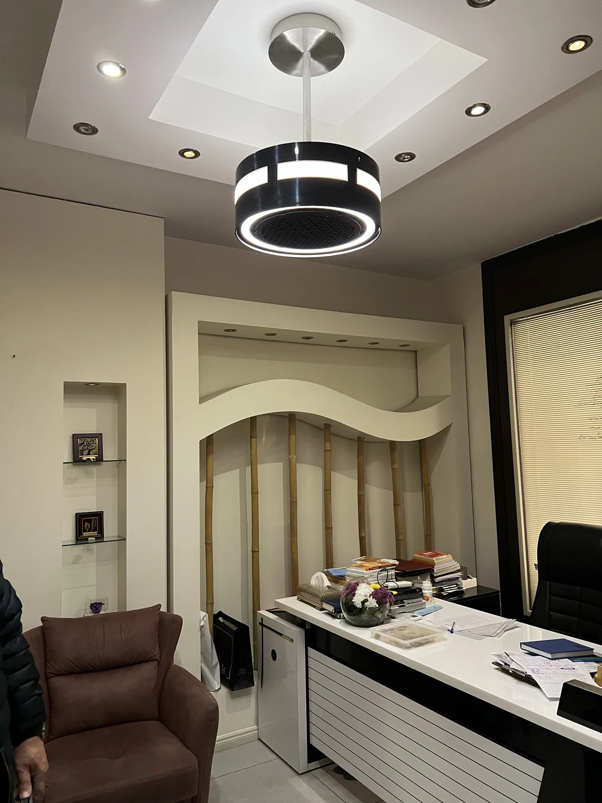 Black dp air purifier above an office desk