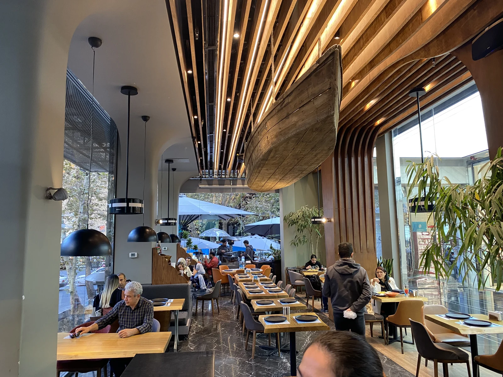 dp air purifiers in a restaurant with a wooden ceiling and guests